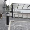 20W Black Dome LED Bollard lighting up a business park car park.